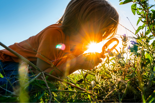 child with magnifying glass